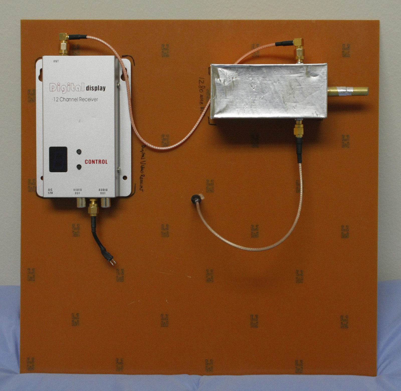 Back of crosshair antenna showing connected cavity filter and video receiver