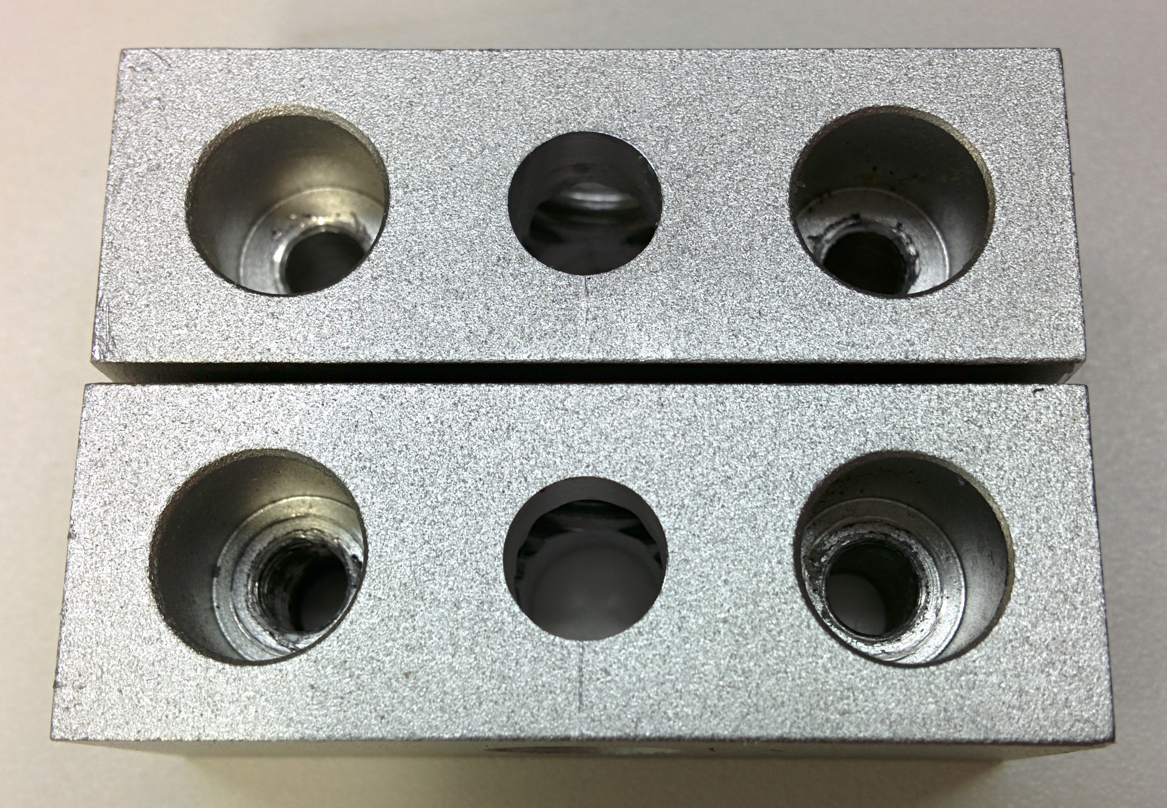 Spacer blocks with 6.35mm holes milled in center per drawing above.